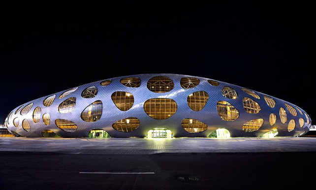 Exterior of Borisov Arena. From its façade holes we can see the interior gallery that works as a high street. 